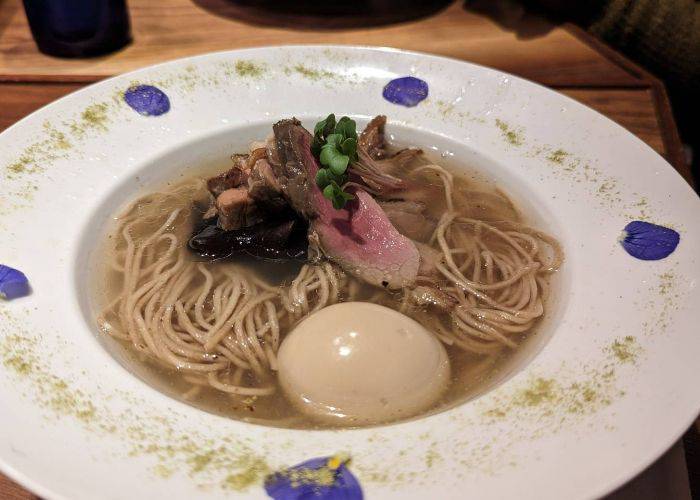 The delicious visage of Gion Duck Noodles, featuring noodles, duck and an egg.